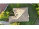 Aerial view of a meticulously landscaped home with a tile roof, surrounded by lush greenery at 215 Juniper Ridge Ct, Sanford, FL 32771