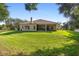 Expansive backyard view showcasing the lush lawn and screened-in patio of this lovely home at 215 Juniper Ridge Ct, Sanford, FL 32771