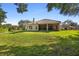Expansive backyard view showcasing the lush lawn and screened-in patio of this lovely home at 215 Juniper Ridge Ct, Sanford, FL 32771