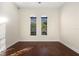 Bright empty bedroom with hardwood floors and two large windows at 215 Juniper Ridge Ct, Sanford, FL 32771