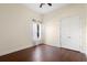 Bright bedroom featuring hardwood floors, a ceiling fan, and a window at 215 Juniper Ridge Ct, Sanford, FL 32771