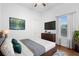 Well-lit bedroom with a ceiling fan, hardwood floors, and a view of the backyard at 215 Juniper Ridge Ct, Sanford, FL 32771