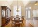 Elegant dining room featuring hardwood floors, a large window, and a decorative chandelier at 215 Juniper Ridge Ct, Sanford, FL 32771
