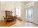 Bright and sunny dining area with grand chandelier, hardwood floors, and a large window at 215 Juniper Ridge Ct, Sanford, FL 32771