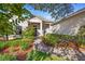 Beautiful home showcasing a well-manicured lawn, walkway, and mature landscaping at 215 Juniper Ridge Ct, Sanford, FL 32771