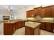 The open kitchen features an island, granite counters, custom cabinets and updated stainless appliances at 215 Juniper Ridge Ct, Sanford, FL 32771