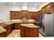 The spacious kitchen features an island, granite counters, stainless appliances, and custom wood cabinets at 215 Juniper Ridge Ct, Sanford, FL 32771