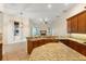 The eat-in kitchen boasts granite counters, tile floors, stainless appliances, and custom wood cabinets at 215 Juniper Ridge Ct, Sanford, FL 32771