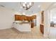 Bright eat-in kitchen with wood cabinetry, tile floors, stainless appliances and stone counters at 215 Juniper Ridge Ct, Sanford, FL 32771