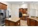Well-appointed kitchen with granite countertops, wood cabinets, tiled backsplash, and stainless appliances at 215 Juniper Ridge Ct, Sanford, FL 32771
