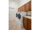 Bright laundry room with cabinets, sink and washer dryer at 215 Juniper Ridge Ct, Sanford, FL 32771