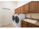 Laundry room with washer, dryer, sink and cabinetry at 215 Juniper Ridge Ct, Sanford, FL 32771