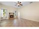 Spacious living room with a fireplace, neutral tones, and tile flooring at 215 Juniper Ridge Ct, Sanford, FL 32771