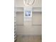 Walk-in closet featuring white shelving, built-in organizers, and accent window at 215 Juniper Ridge Ct, Sanford, FL 32771