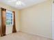 Cozy bedroom featuring neutral walls, carpet floors, a ceiling fan and a window with curtains at 2153 Cypress Villas Dr, Orlando, FL 32825