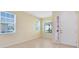 Bright foyer with tile flooring, large windows, and a view of the front door entrance at 2153 Cypress Villas Dr, Orlando, FL 32825