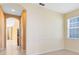 Hallway featuring tile flooring with neutral paint and an archway leading to the stairs at 2153 Cypress Villas Dr, Orlando, FL 32825