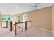 Upstairs hallway featuring natural light and overlooking the downstairs living area at 2153 Cypress Villas Dr, Orlando, FL 32825