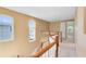 Second floor hallway featuring natural light and wood railing at 2153 Cypress Villas Dr, Orlando, FL 32825