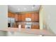 Well-lit kitchen featuring stainless steel appliances, light countertops, and wooden cabinetry at 2153 Cypress Villas Dr, Orlando, FL 32825
