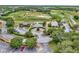 Expansive aerial view of golf course, clubhouse and parking, and surrounding lush landscaping at 23820 Sardinia Dr, Sorrento, FL 32776