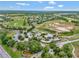 Aerial view of the community with golf course, trees, and a landscaped entrance at 23820 Sardinia Dr, Sorrento, FL 32776