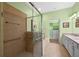 Bathroom featuring a tiled shower with glass door and a walk-in closet at 23820 Sardinia Dr, Sorrento, FL 32776