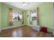Bedroom featuring wood floors and windows with blinds and curtains at 23820 Sardinia Dr, Sorrento, FL 32776