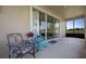 Cozy covered patio with comfortable seating and view of green space at 23820 Sardinia Dr, Sorrento, FL 32776