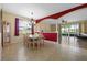 Spacious dining room with a view of the living area and outdoor space at 23820 Sardinia Dr, Sorrento, FL 32776