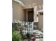 Close-up of the front door with a decorative picket fence and brick accents at 23820 Sardinia Dr, Sorrento, FL 32776