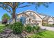 Landscaped front yard featuring lush greenery and shade from a mature tree at 23820 Sardinia Dr, Sorrento, FL 32776