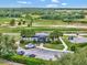 Charming golf clubhouse entrance with well manicured landscaping and ample parking at 23820 Sardinia Dr, Sorrento, FL 32776