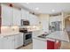 Well-equipped kitchen featuring granite counters, stainless steel appliances, and white cabinetry at 23820 Sardinia Dr, Sorrento, FL 32776