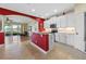 Open-concept kitchen with white cabinets, granite countertops, and modern appliances at 23820 Sardinia Dr, Sorrento, FL 32776
