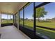 View from screened patio overlooking the spacious backyard and greenery at 23820 Sardinia Dr, Sorrento, FL 32776