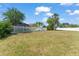 Spacious backyard with lush greenery and tall trees at 2511 Brookstone Dr, Kissimmee, FL 34744