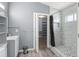 Modern bathroom with a walk-in shower, sleek vanity, and a view into the closet at 2511 Brookstone Dr, Kissimmee, FL 34744