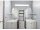 Modern bathroom featuring dual sinks, grey cabinets, and framed mirrors above each sink at 2511 Brookstone Dr, Kissimmee, FL 34744