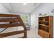 Cozy bedroom with a bunk bed, a patterned chair, and a view of the backyard at 2511 Brookstone Dr, Kissimmee, FL 34744