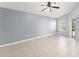 Spacious bedroom with neutral paint, tile flooring, and a sliding door to the outside at 2511 Brookstone Dr, Kissimmee, FL 34744