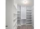 Walk-in closet with custom shelving and drawers, providing ample storage space at 2511 Brookstone Dr, Kissimmee, FL 34744