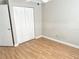 Well-lit bedroom with hardwood floors, featuring ample closet space with bi-fold doors at 2524 Woodgate Blvd # 201, Orlando, FL 32822