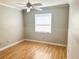 Bright bedroom with hardwood floors and a window providing natural light at 2524 Woodgate Blvd # 201, Orlando, FL 32822