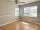Inviting bedroom with natural light, hardwood flooring, and a ceiling fan for enhanced comfort at 2524 Woodgate Blvd # 201, Orlando, FL 32822