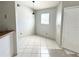 Bright dining area featuring neutral walls and tile floors, illuminated by a modern pendant light at 2524 Woodgate Blvd # 201, Orlando, FL 32822