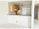Functional kitchen featuring wood cabinetry, matching appliances, and a breakfast bar for casual dining at 2524 Woodgate Blvd # 201, Orlando, FL 32822