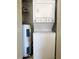 Compact closet with stackable washer and dryer, and a water heater at 2524 Woodgate Blvd # 201, Orlando, FL 32822