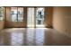 Bright living room featuring tile floors, lots of natural light and a sliding glass door to the balcony at 2524 Woodgate Blvd # 201, Orlando, FL 32822