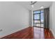 Bright bedroom features wood floors, city views, and natural light at 260 S Osceola Ave # 1207, Orlando, FL 32801